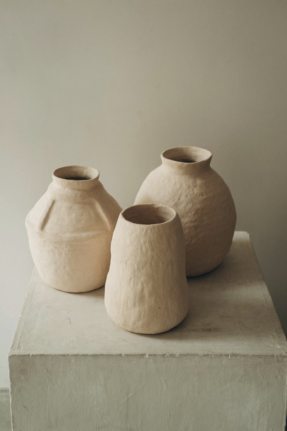 Brown clay jars on a white table