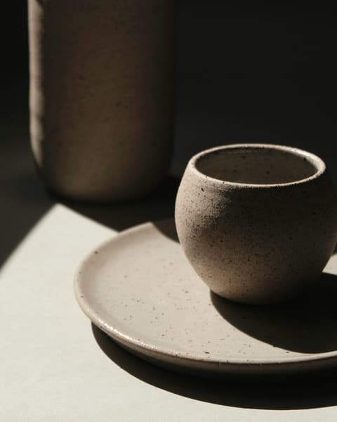 Dark moss-green jug and cup on a matching plate