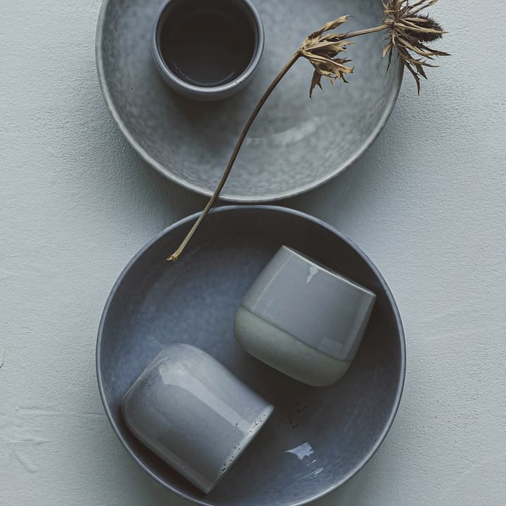 Two slate-blue plates seen from above, detail of the glaze