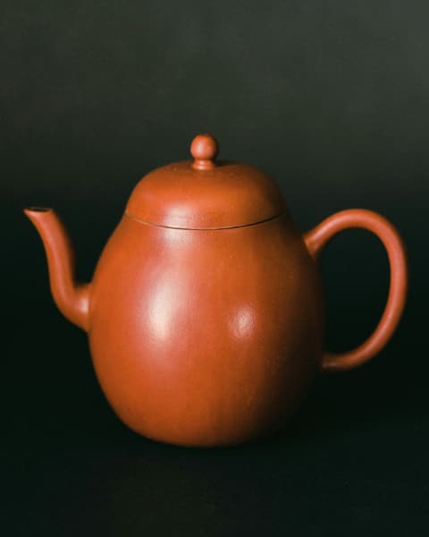 Terracotta teapot on a dark background