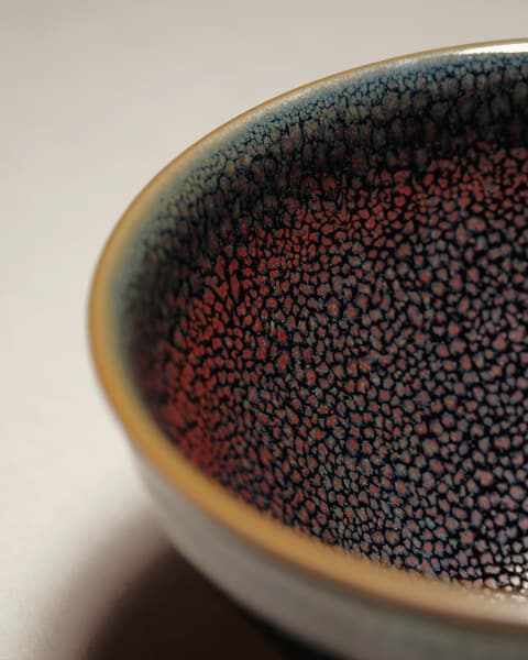 Bowl with a deep iron-brown tenmoku glaze and blue speckle