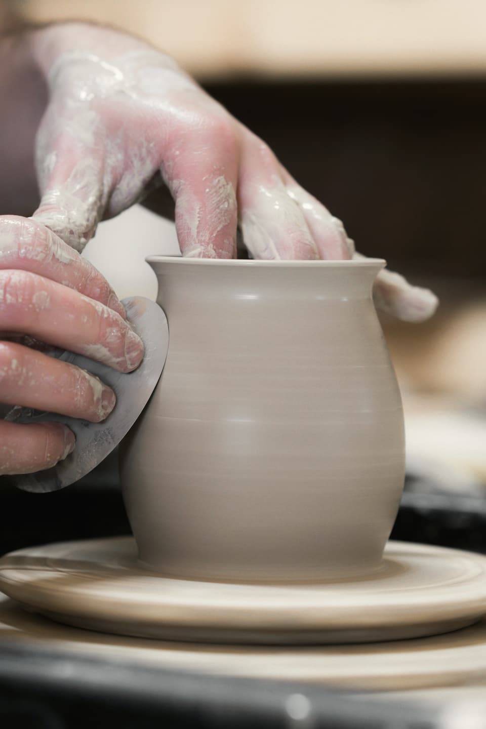 A pot being centred on the wheel